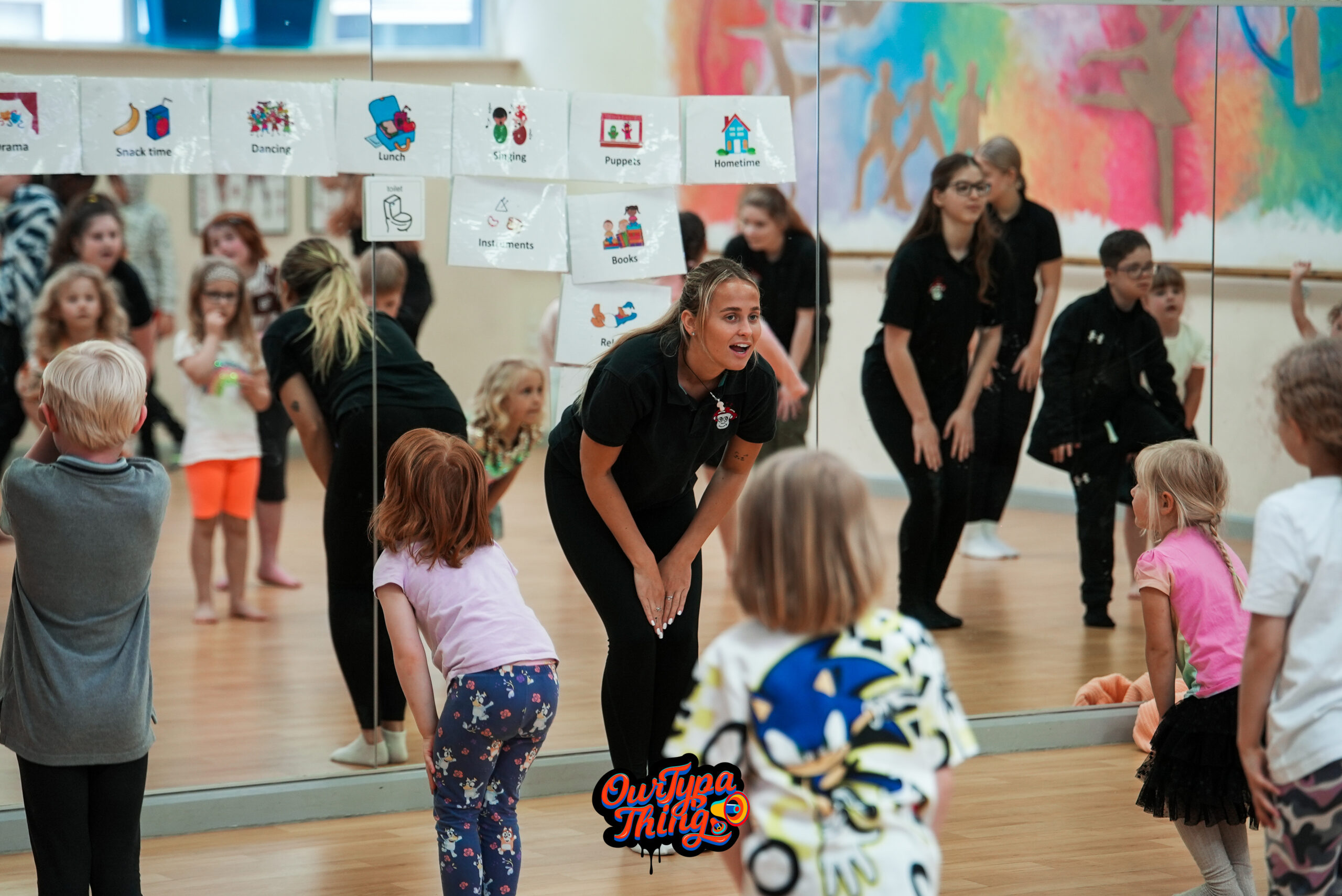 A dance teacher teaches a class of students